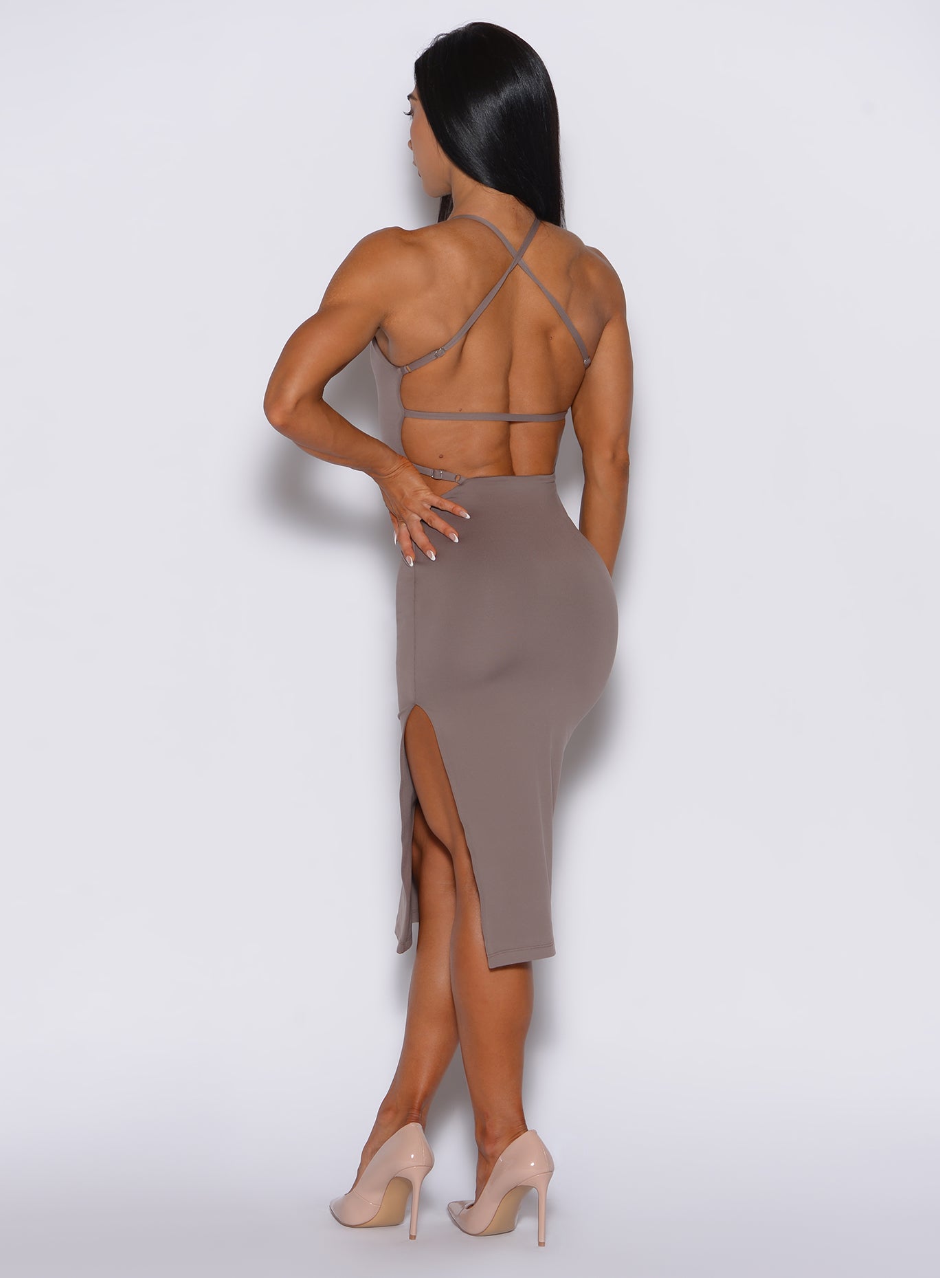 back profile picture of a model with her left hand on waist wearing our bombshell bunny dress in espresso color