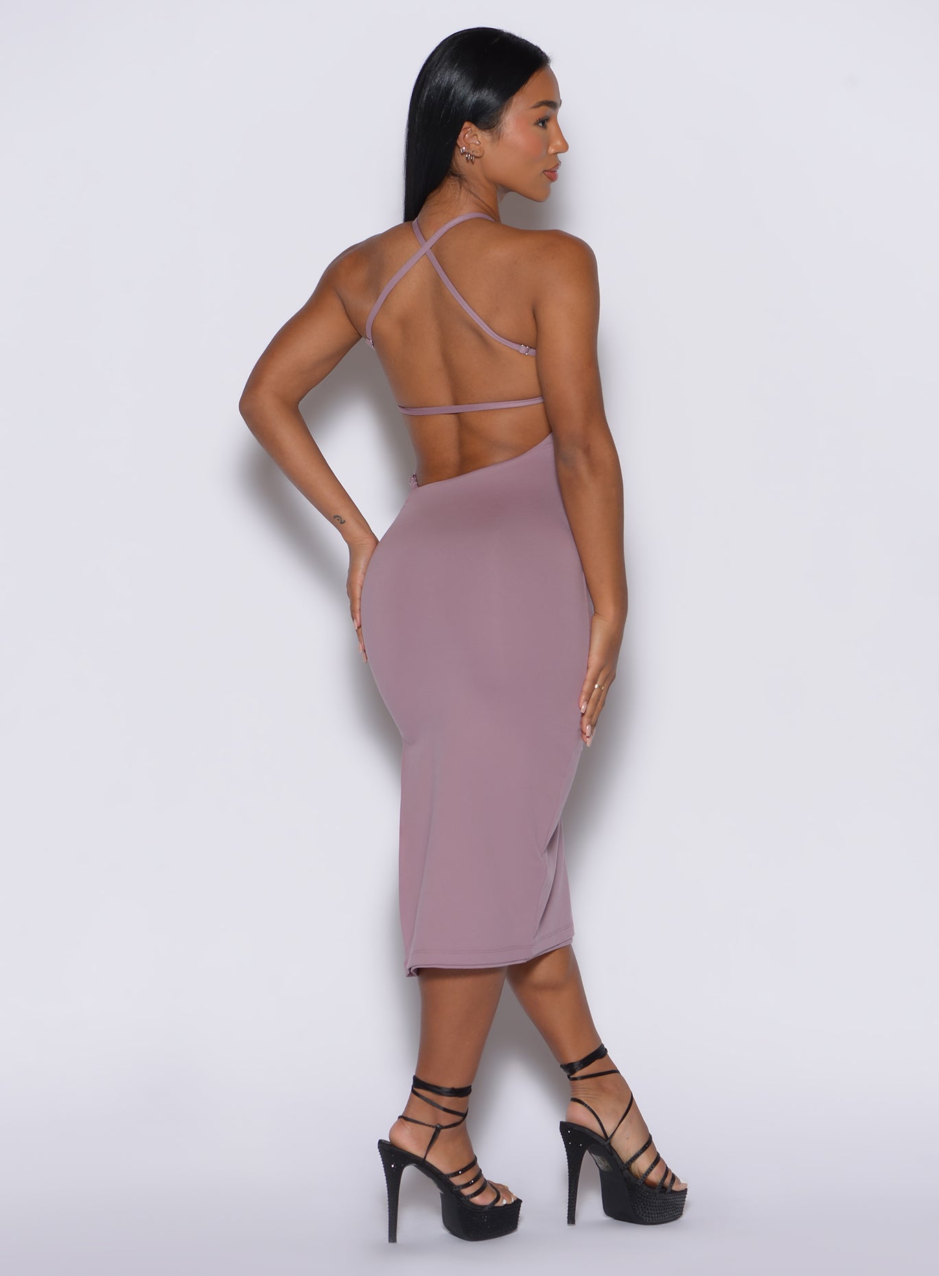 back profile view of a model wearing our bombshell bunny dress in light mauve color