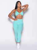 front profile view of a model looking to the left side wearing the Bombshell Bunny Leggings in Aquatic awe color
