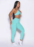 right side profile view of a model wearing the Bombshell Bunny Leggings in Aquatic awe color