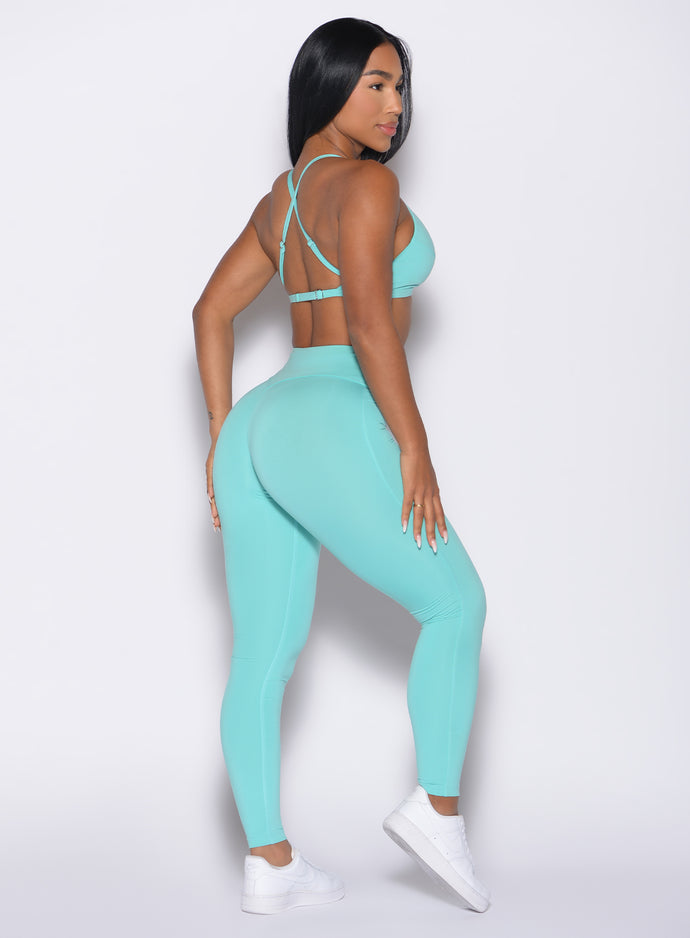 back right side profile view of a model wearing the Bombshell Bunny Leggings in Aquatic awe color