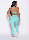 back profile view of a model wearing the Bombshell Bunny Leggings in Aquatic awe color