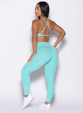 back left side profile view of a model wearing the Bombshell Bunny Leggings in Aquatic awe color