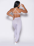 back profile view of a model wearing the Bombshell Bunny Leggings in Galactic Lilac color