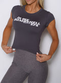 front profile view of a model holding the bottom hem wearing the Bombshell Era Tee in solid champion gray color 