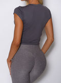 close up back profile view of a model wearing the Bombshell Era Tee in solid champion gray color 