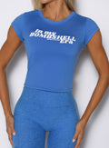 close up front view of a model wearing the Bombshell Era Tee in solid legacy blue color 