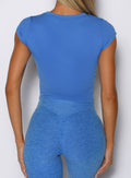 close up back profile view of a model wearing the Bombshell Era Tee in solid legacy blue color 