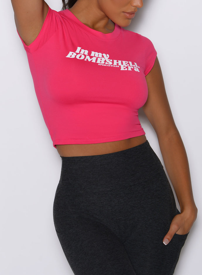 close up front view of a model wearing the Bombshell Era Tee in solid victory ruby color 