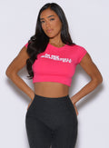 front view of a model with both hands on her back wearing the Bombshell Era Tee in solid victory ruby color 