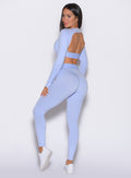 left side profile view of our model looking over her shoulder wearing the Bombshell Active Leggings in Baby Lavender color