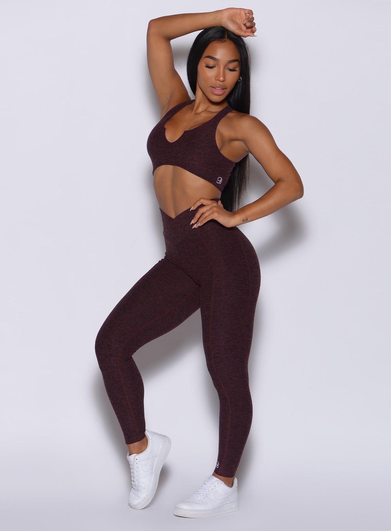 Front profile view of a model in our Brazilian Contour Leggings in port color and a matching bra