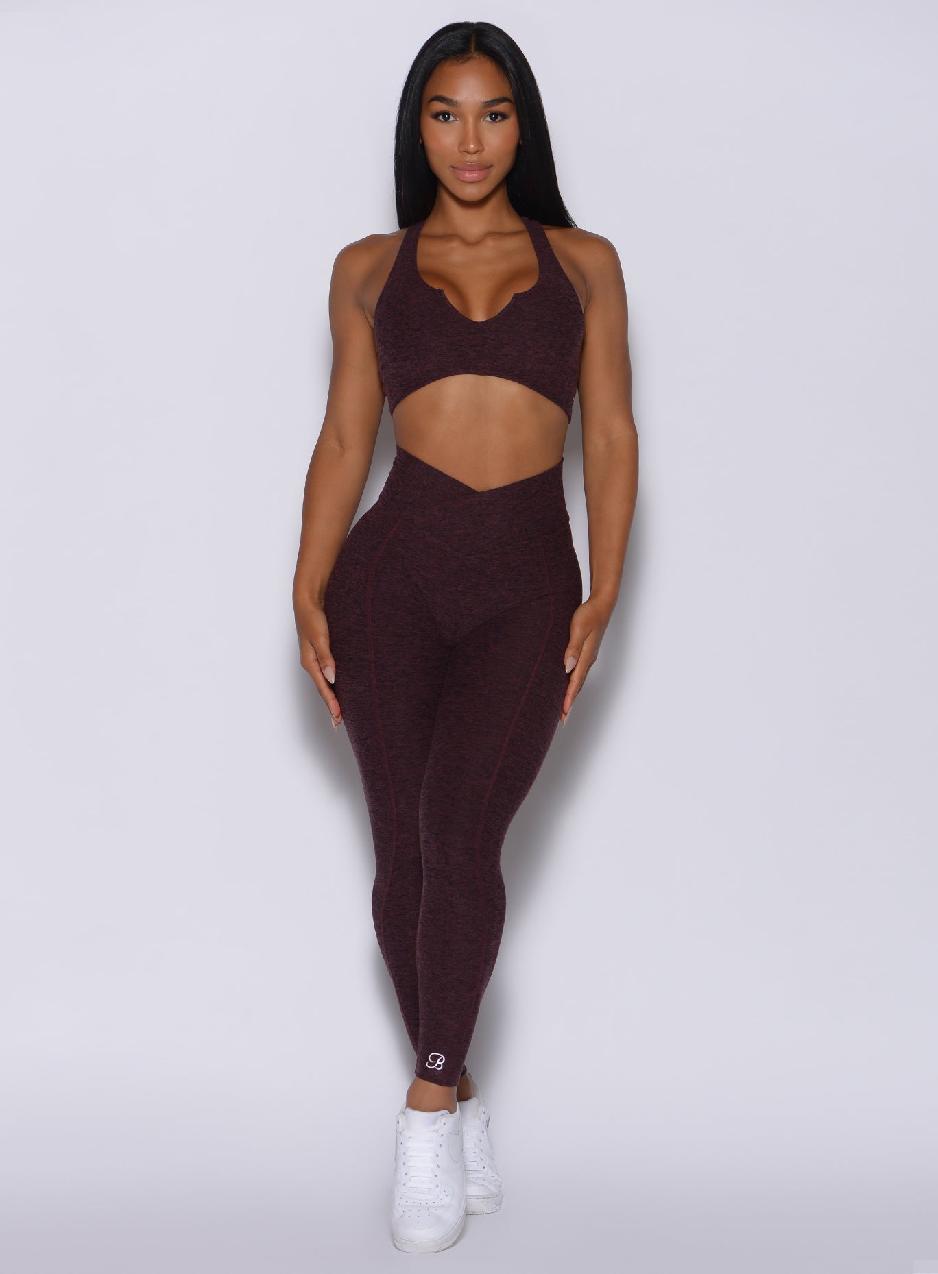 Front  profile view of a model in our Brazilian Contour Leggings in port color and a matching bra