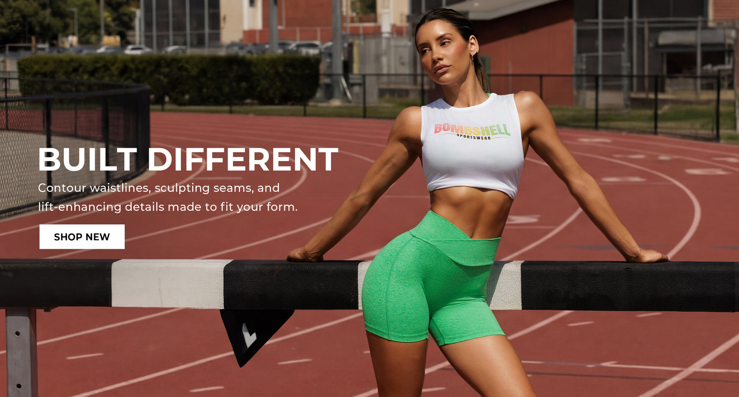 Woman in green athletic wear shorts and a white tank top that says BOMBSHELL SPORTSWEAR on a track with promotional text overlay that says BUILT DIFFERENT. Contour Waistlines, sculpting seams, and lift-enhancing details, made to fit your form. SHOP NEW