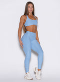 front right side profile view of a model wearing the Built Leggings in Blue mist color