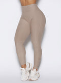 close up front view of a model wearing the Built Leggings in Desert taupe color