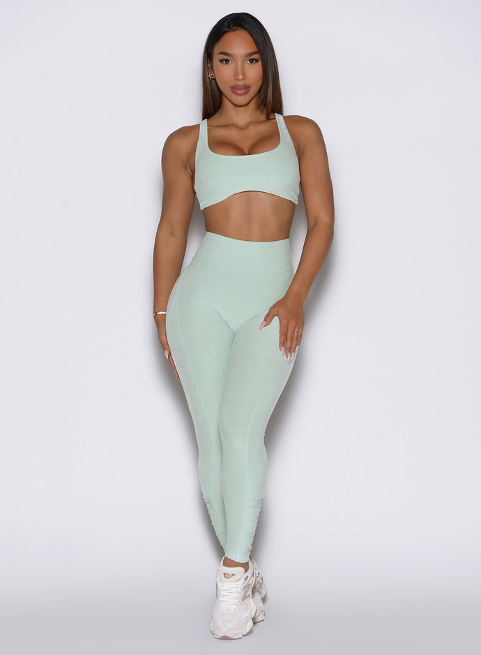 model wearing the built leggings in soft aloe color paired with the matching bra