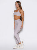 front left side profile view of a model wearing the Built Leggings in violet ice color