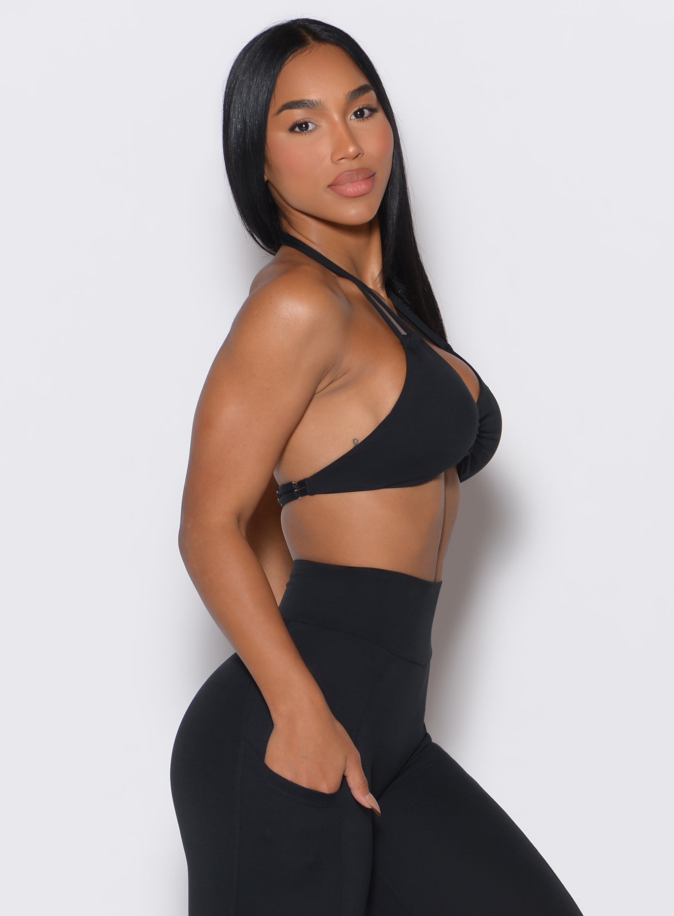 A stunning right-side profile view showcasing our black Butterfly Sports Bra paired elegantly with matching shorts, worn by our exquisite model. 