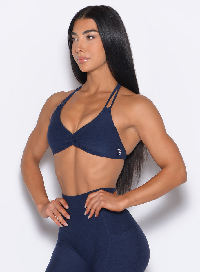front left side profile view of our model wearing the Butterfly Sports Bra in Cosmic Blue color