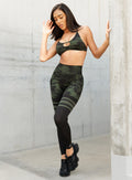 front profile view of a model in outdoors wearing the Scrunch Thigh Highs in Green/Black camo color