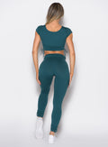 back profile view of a model wearing the Cargo Edge Leggings in dark sea color