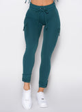 close up front profile shot of a model wearing the Cargo Edge Leggings in dark sea color