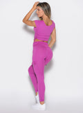 back profile view of a model facing to the left side wearing the Cargo Edge Leggings in hyper violet color