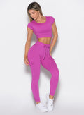 front profile view of a model wearing the Cargo Edge Leggings in hyper violet color