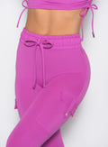close up front profile shot of a model wearing the Cargo Edge Leggings in hyper violet color
