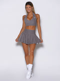 front view of a model wearing the Champion Skort in Champion Gray color 