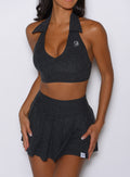 close up front view of a model wearing the Champion Skort in Charcoal color 