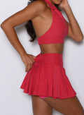 close up right side view of a model wearing the Champion Skort in Victory Ruby color 