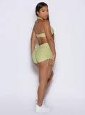 side view of a model wearing the Charm Fit shorts in serpentine color