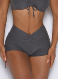 close up front view of a model wearing the Charm Fit shorts in steel shadow color