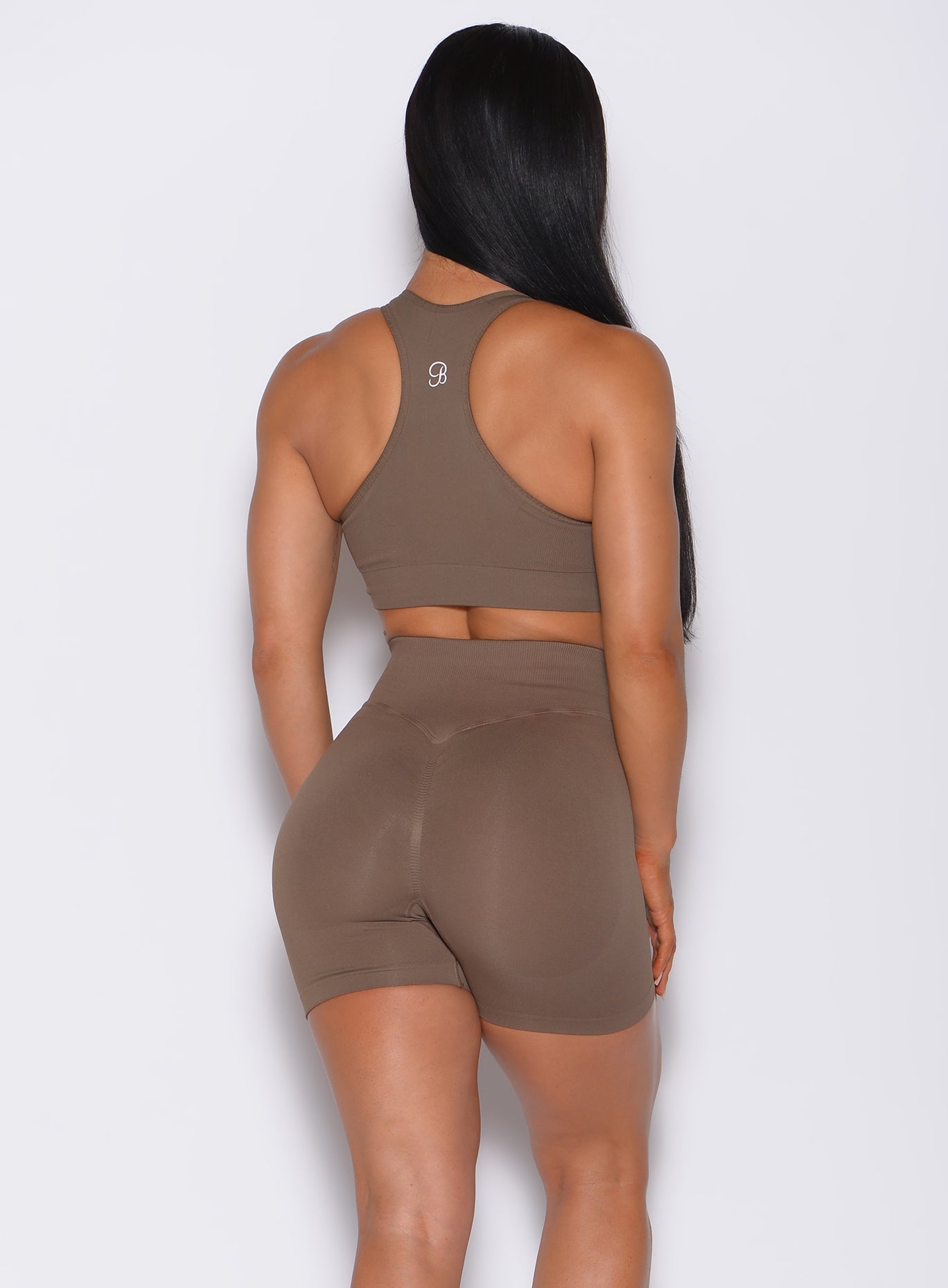 back profile view of a model wearing our smooth seamless bra in beachwood color along with the matching shorts