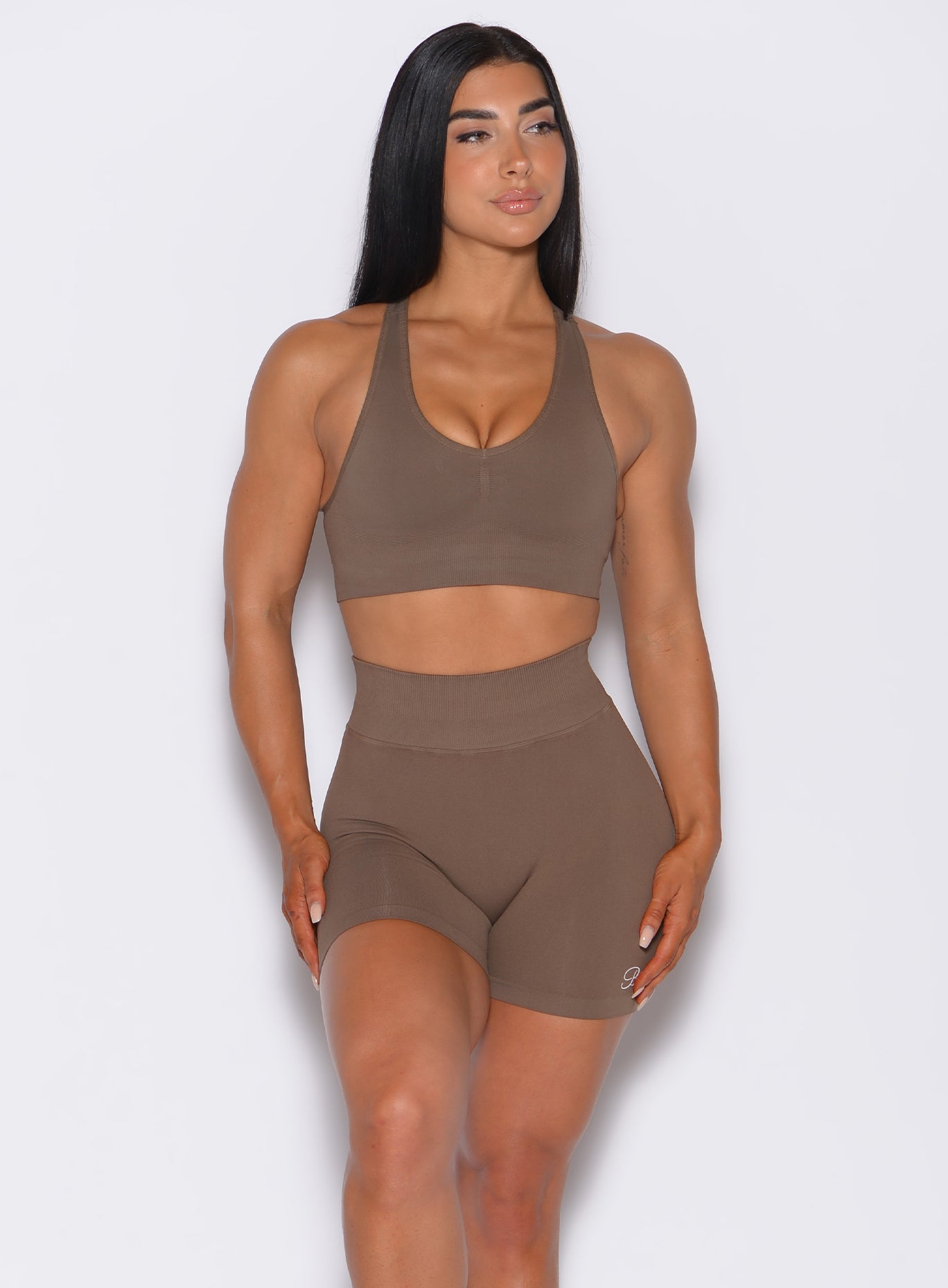 front profile view of a model wearing our smooth seamless bra in beachwood color along with the matching shorts