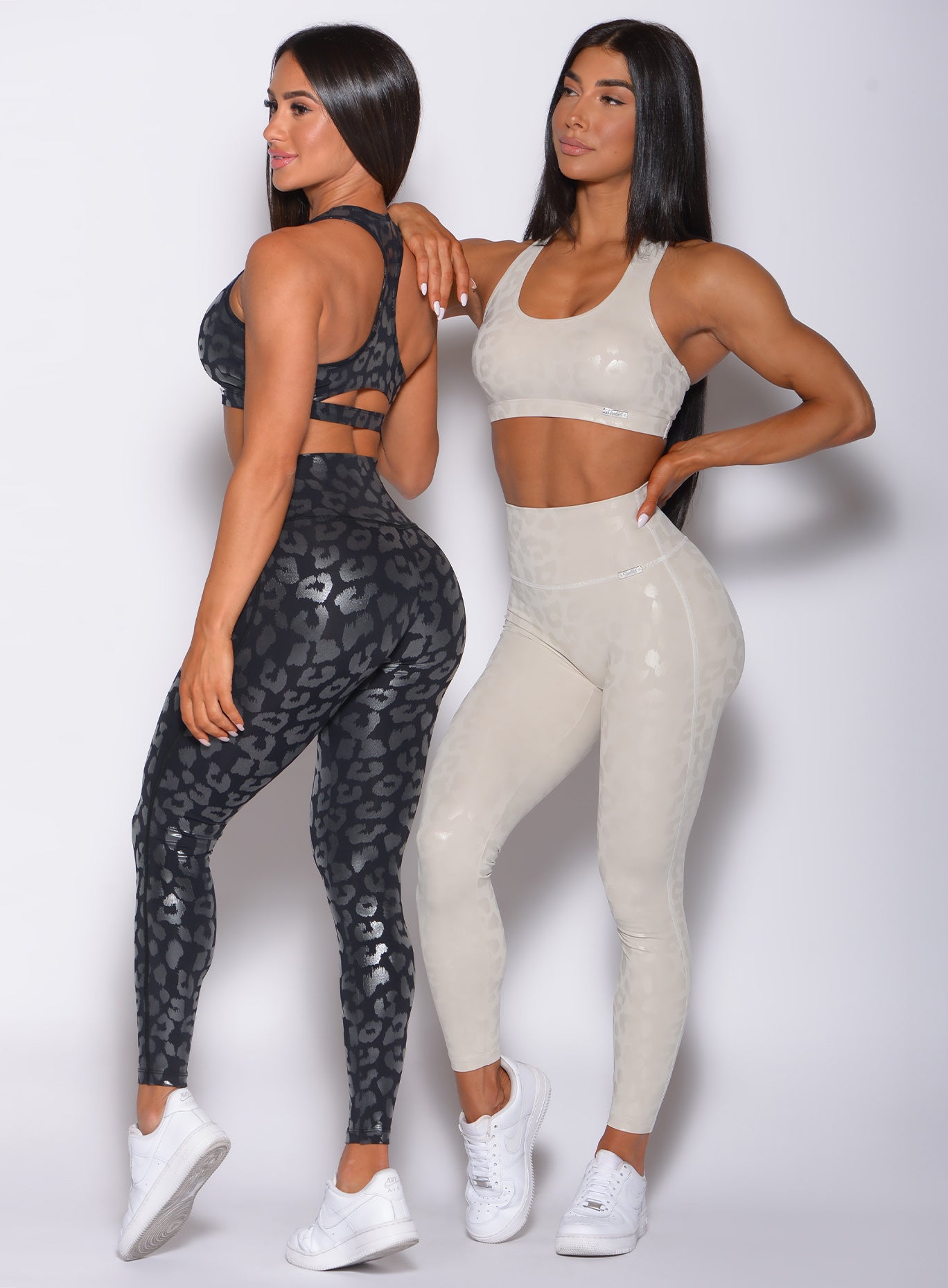A picture of two models standing side by side wearing our shine leopard leggings sets in black and bluff leopard color 