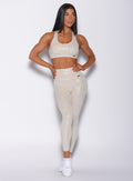 front profile view of a model wearing our shine leopard leggings in Buff Leopard color along with the matching sports bra