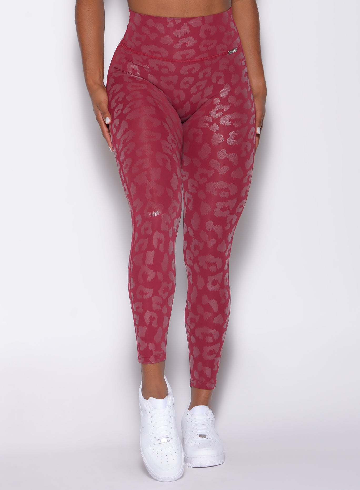 Zoomed in front view of our shine leopard leggings is raspberry color 