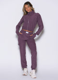 front profile view of a model with both hands inside the side pockets wearing the Cloud Comfort Joggers in regal purple color