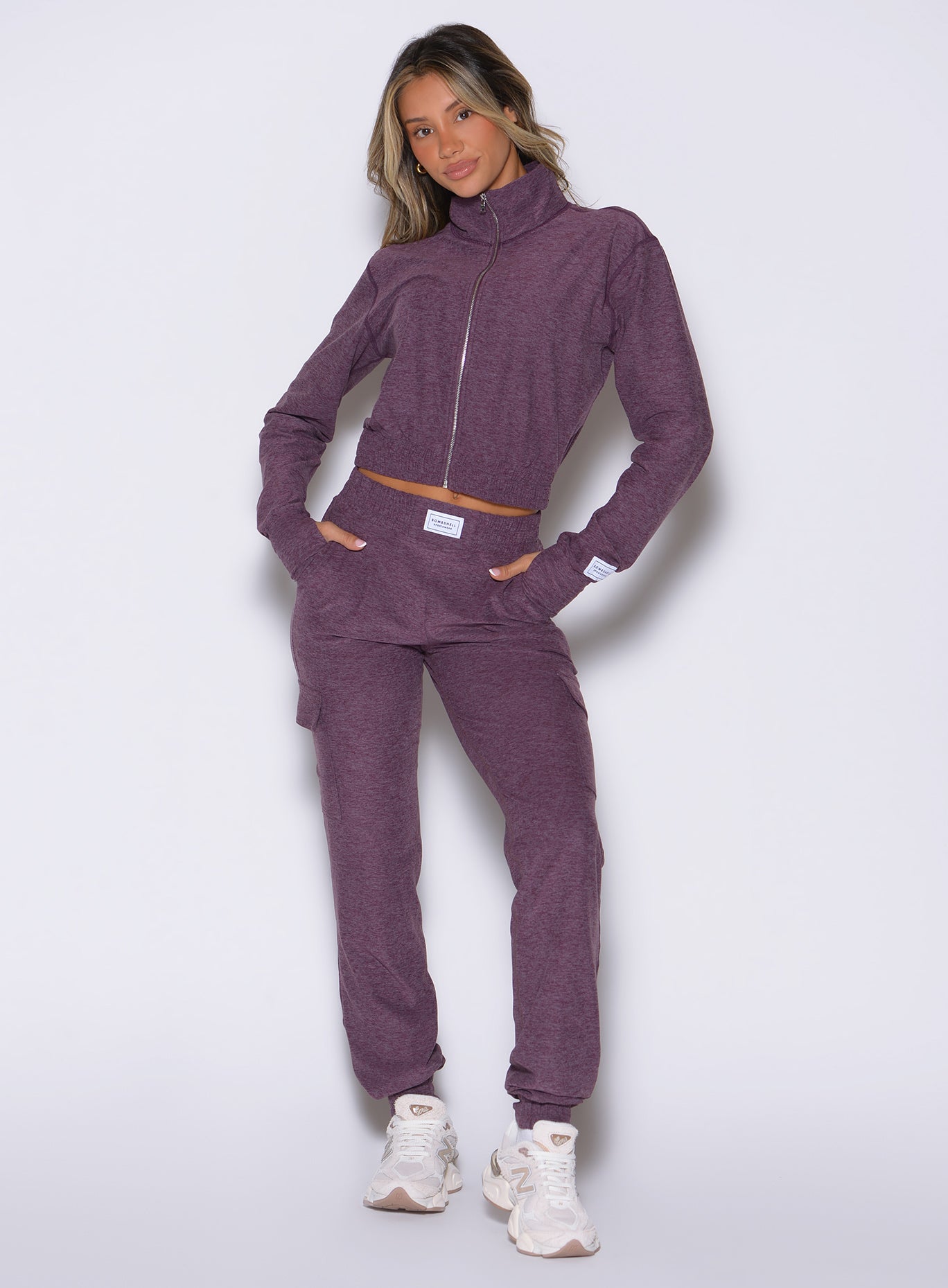 front profile view of a model with both hands inside the side pockets wearing the Cloud Comfort Joggers in regal purple color