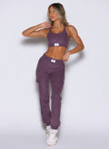 front profile view of a model looking to the right side wearing the Cloud Comfort Joggers in regal purple color