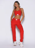 front profile view of a model with both hands inside the side pockets wearing the Cloud Comfort Joggers in scarlet red color