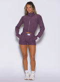 front view of a model with both hands inside the side pockets wearing the Cloud Comfort Shorts in Regal Purple color