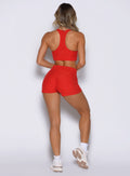 back side view of a model wearing the Cloud Comfort Shorts in Scarlet red color