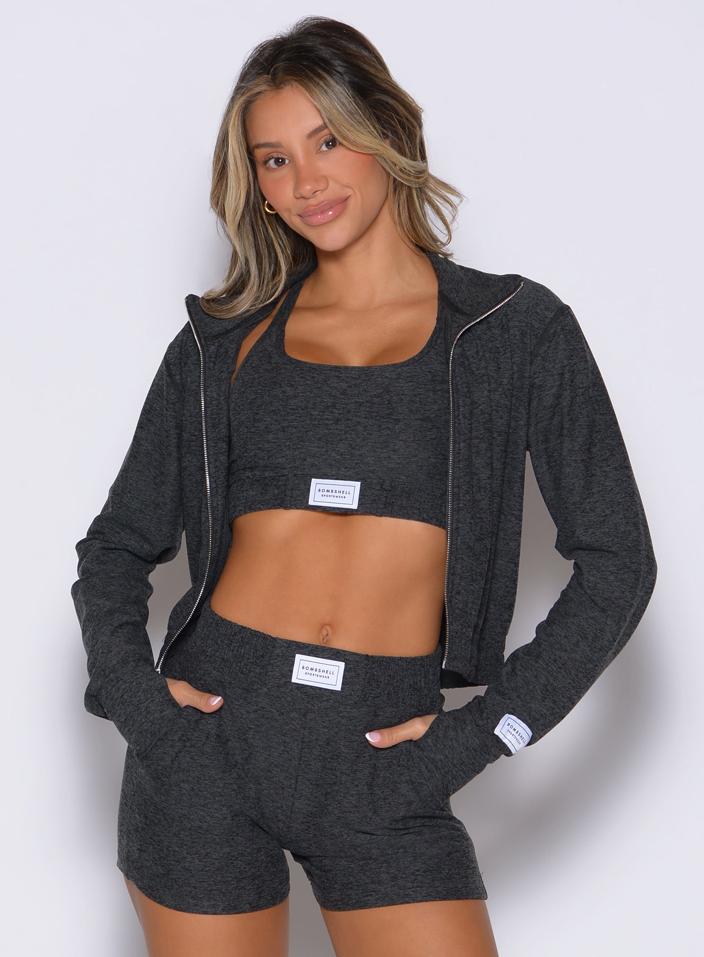 front profile view of a model wearing the Cloud Full Length Jacket in Charcoal color paired with the matching shorts 