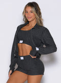 front left side profile view of a model wearing the Cloud Full Length Jacket in Charcoal color