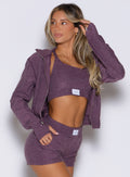front right side profile view of a model wearing the Cloud Full Length Jacket in regal purple color