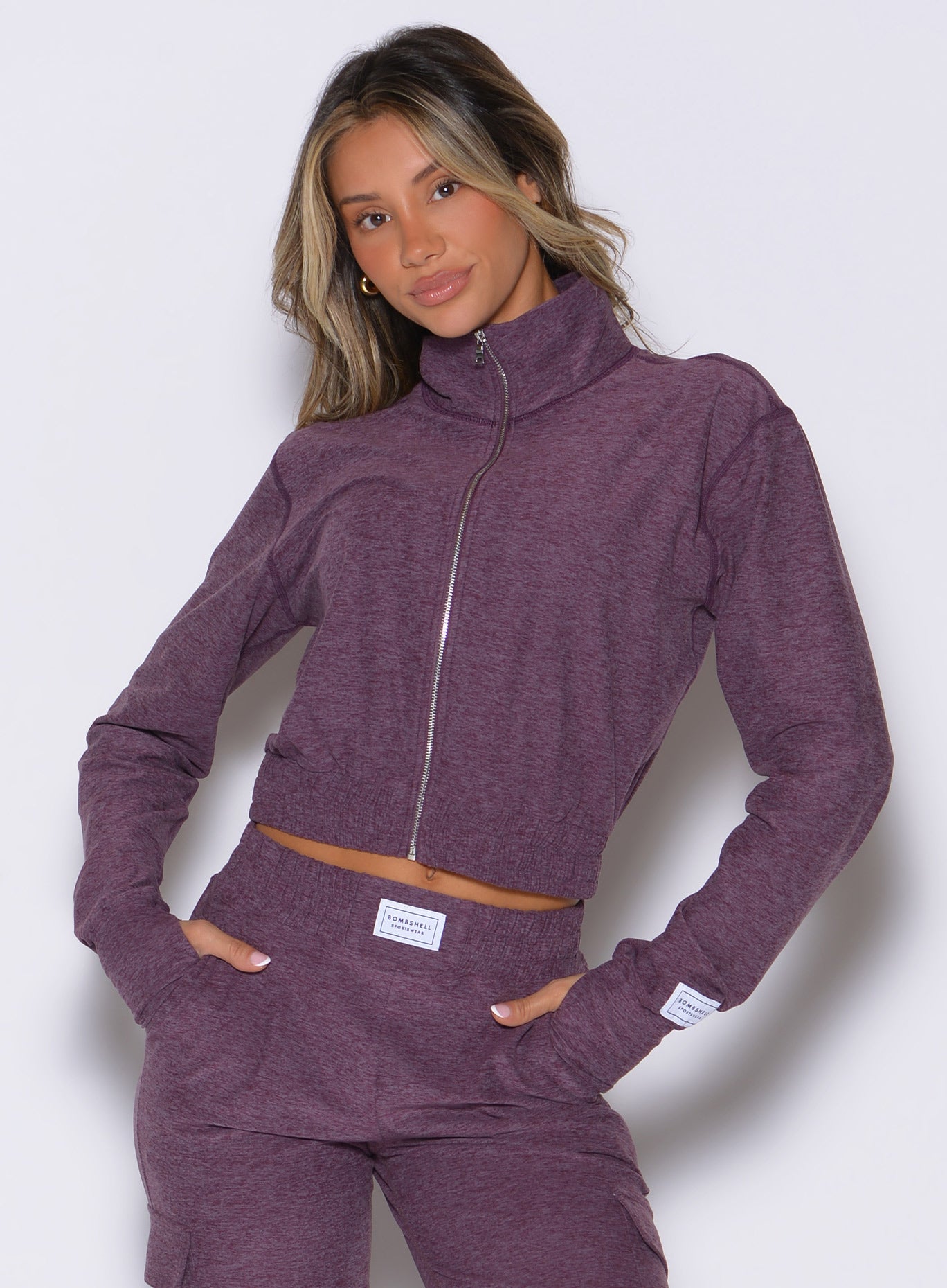 front profile view of a model wearing the Cloud Full Length Jacket in regal purple color